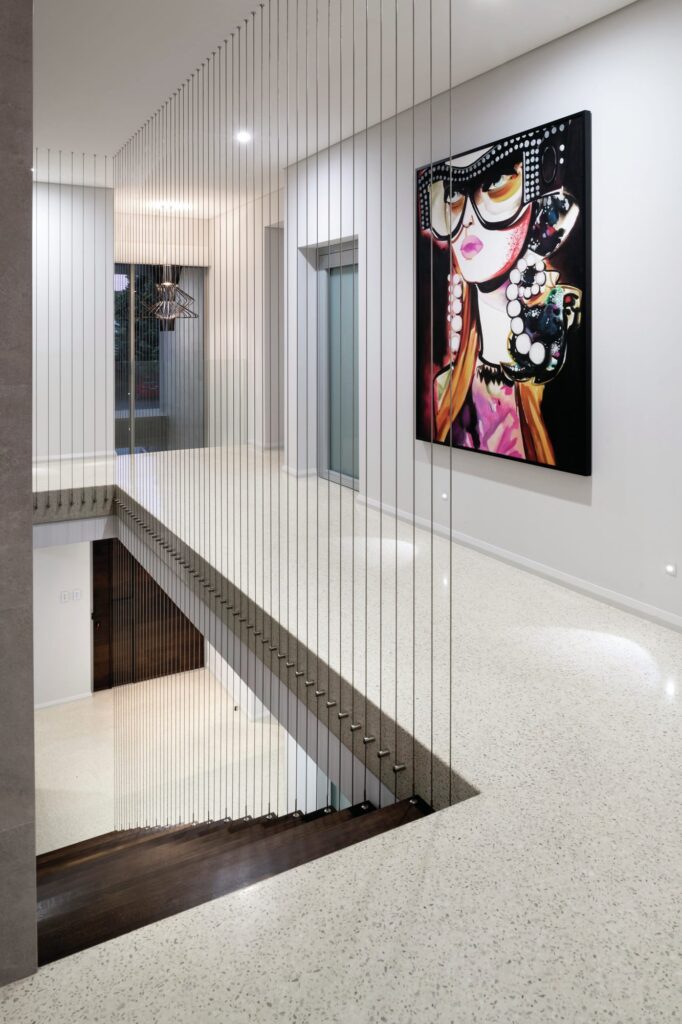Staircase ascending onto a polished white concrete floor