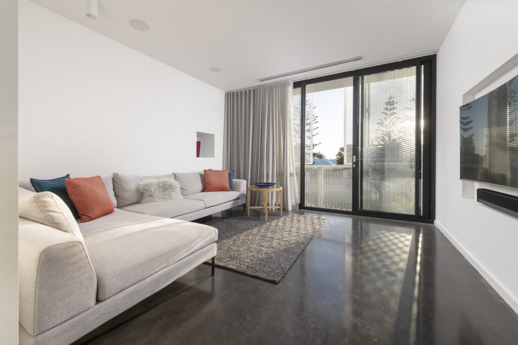 Living room with a polished black concrete floor